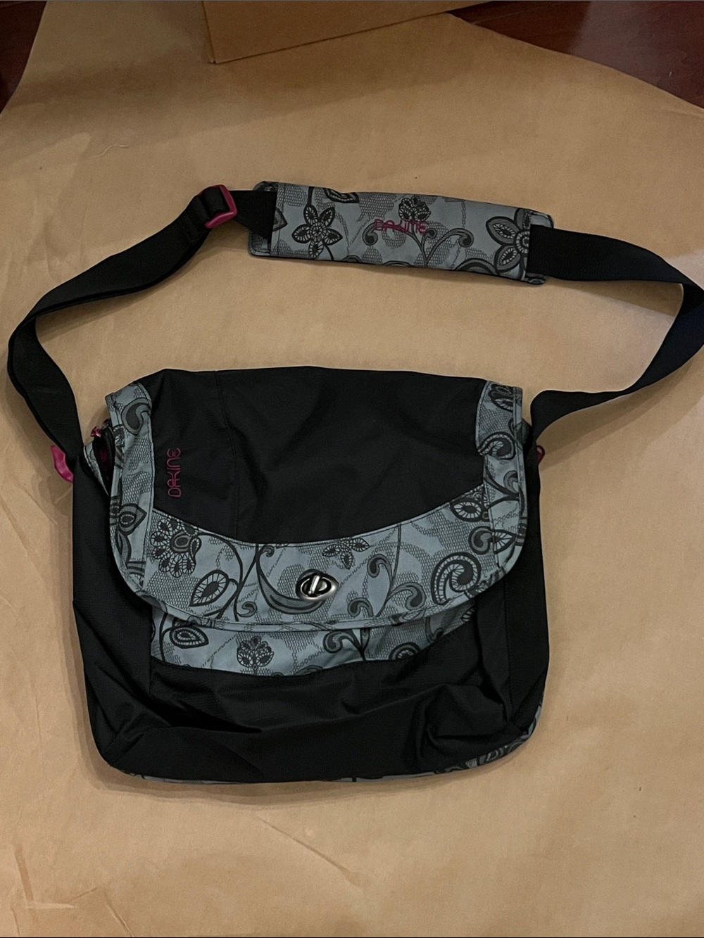 Dakine Black Messenger Bag with Gray Floral Trim and Pink Accents